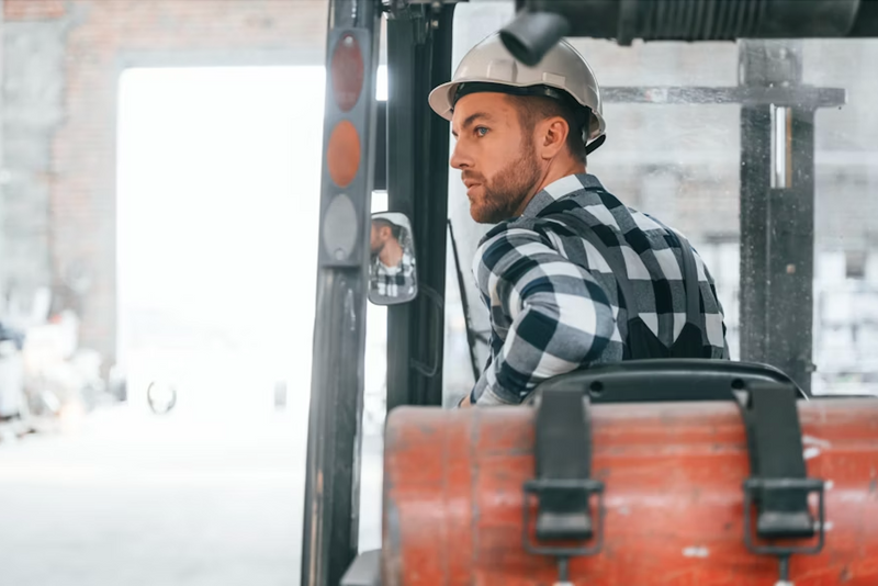 Man operating a forklift in an industrial setting